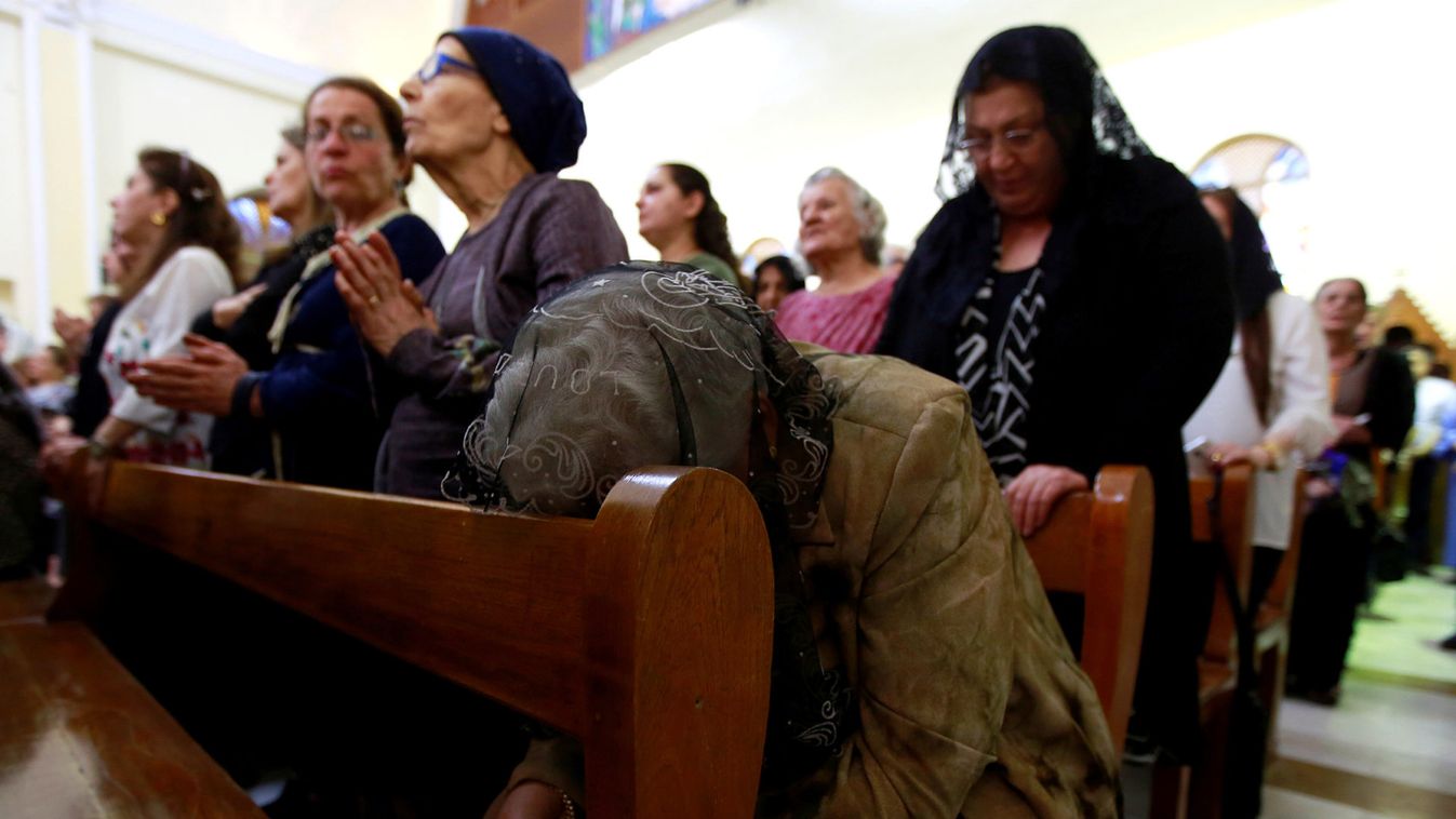 Iraqi Christians pray during a mass to celebrate Palm Sunday at Mar George Chaldean Church in Baghdad