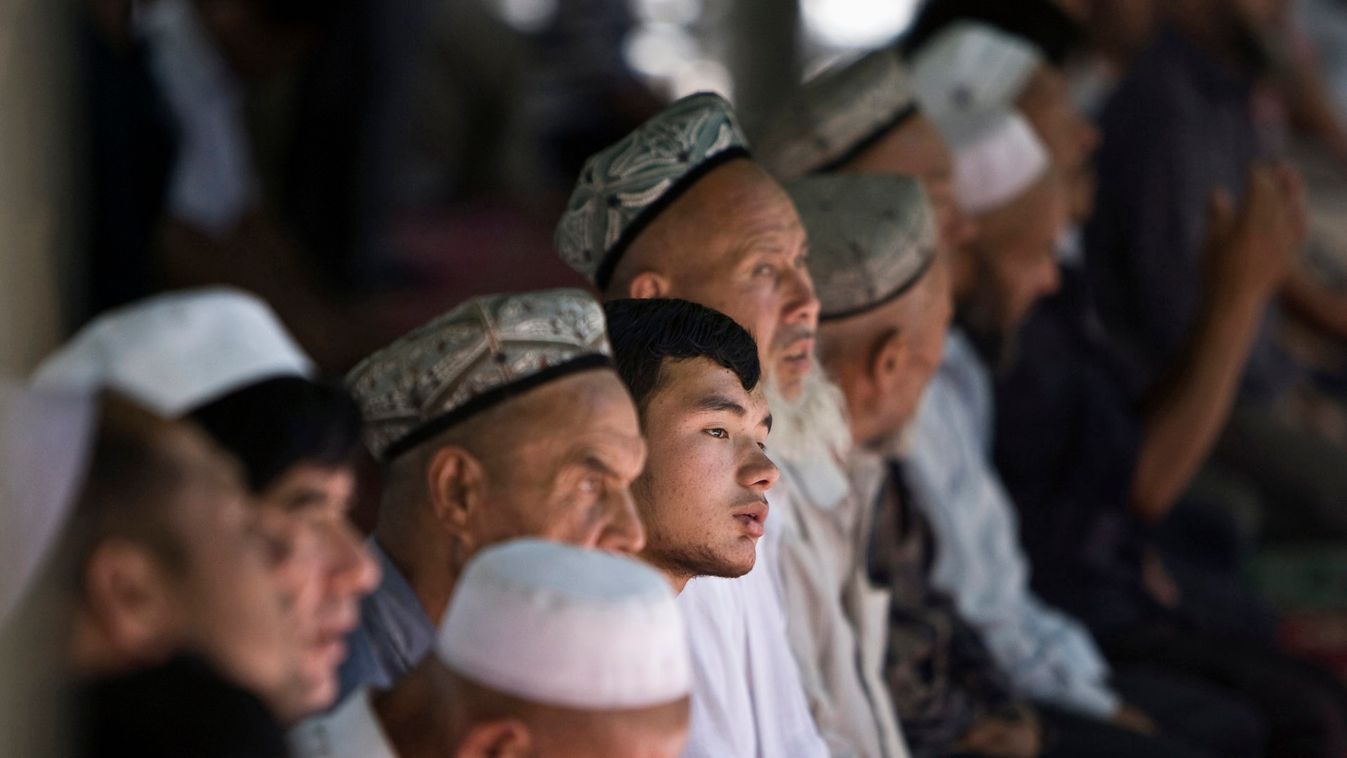 Uighur Muslim worshipers attend an early afternoon prayer session at the Kashgar Idgah mosque in Xinjiang province