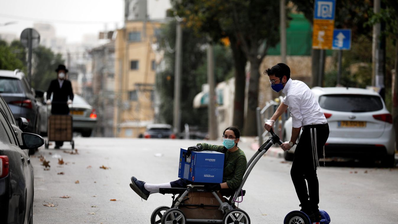 An ultra-Orthodox Jewish youth wearing a mask rides a hoverboard on a street in Bnei Brak, a town badly affected by the coronavirus disease (COVID-19), and which Israel declared a "restricted zone" due to its high rate of infections, near Tel Aviv