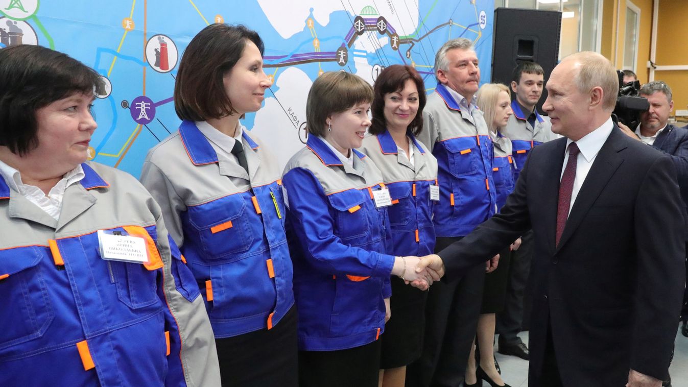 Russian President Vladimir Putin greets workers during an inauguration ceremony of power stations in the cities of Sevastopol and Simferopol