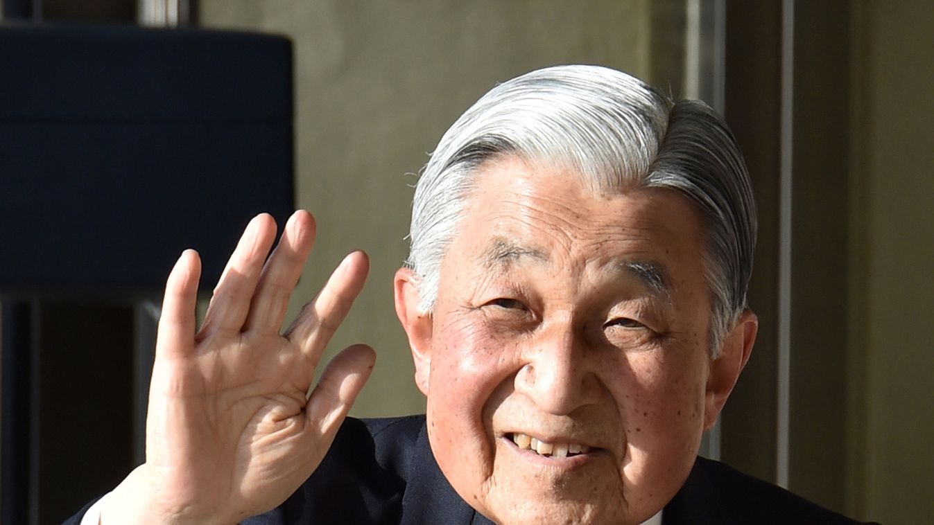 Japan's Emperor Akihito, accompanied by Empress Michiko, waves to well-wishers before leaving Ujiyamada Station after their visit to Ise Jingu shrine in Ise