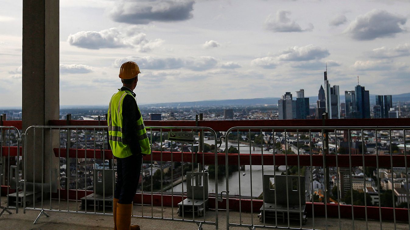 A visitor looks out from the top floor of the construction site of the new headquarters of the ECB during a guided media tour in Frankfurt