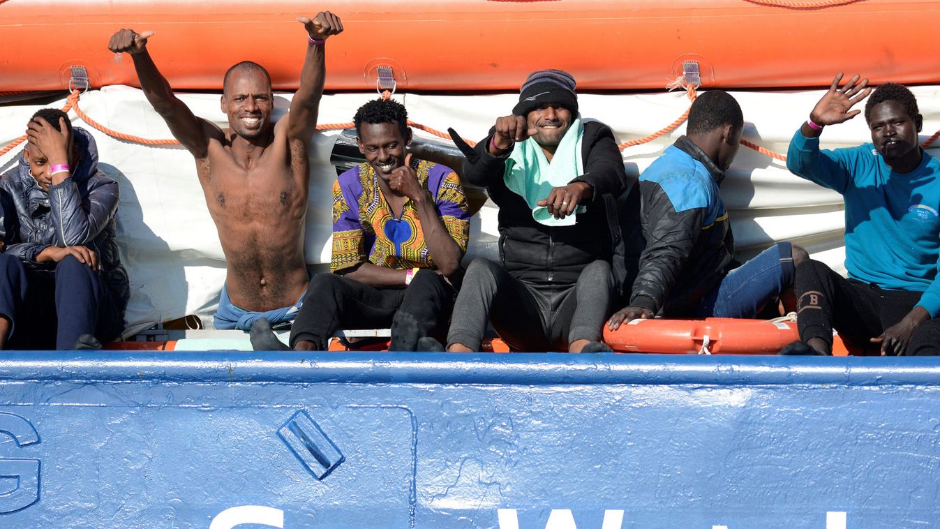 Migrants rest on board the Sea Watch 3 off the coast of Siracusa