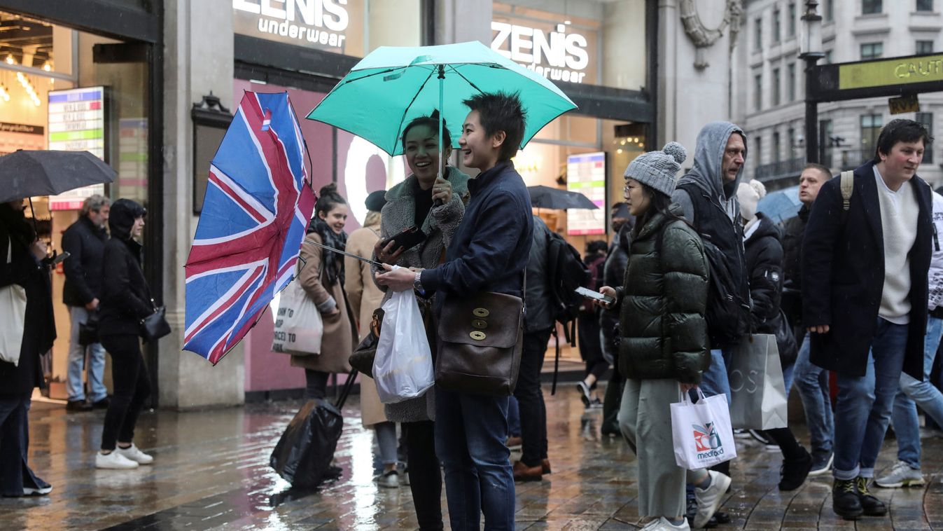 A pedestrian's Union flag umbrella is turned inside out by the wind at Oxford Street during Storm Dennis in London
