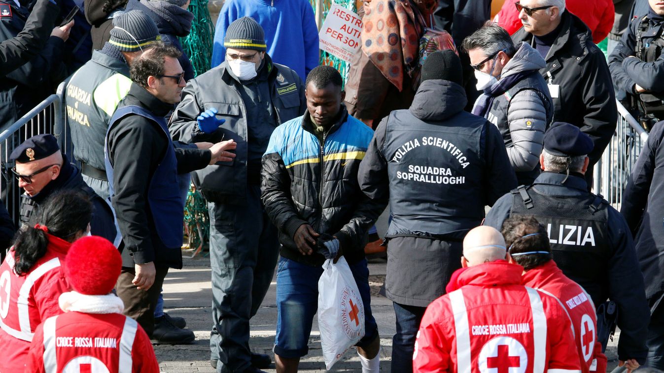 A migrant disembarks from a rescue ship Sea-Watch 3 as they arrive at the port of Catania