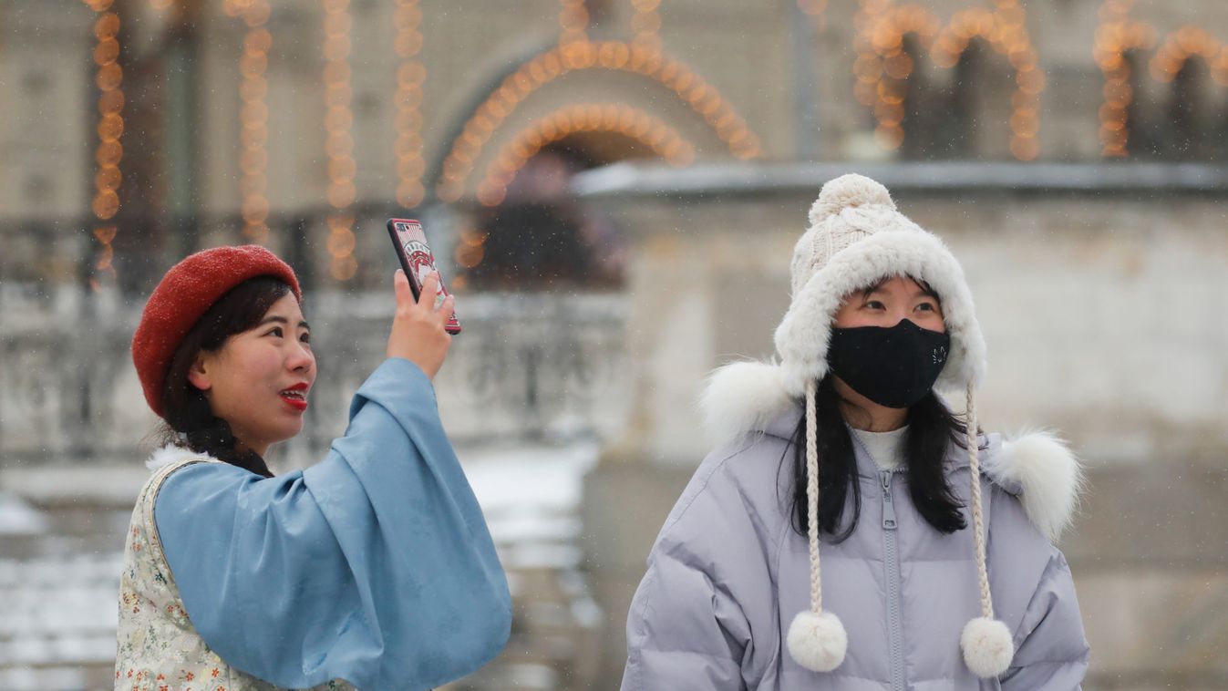 Chinese young women are pictured wearing mask in the Red Square in Moscow