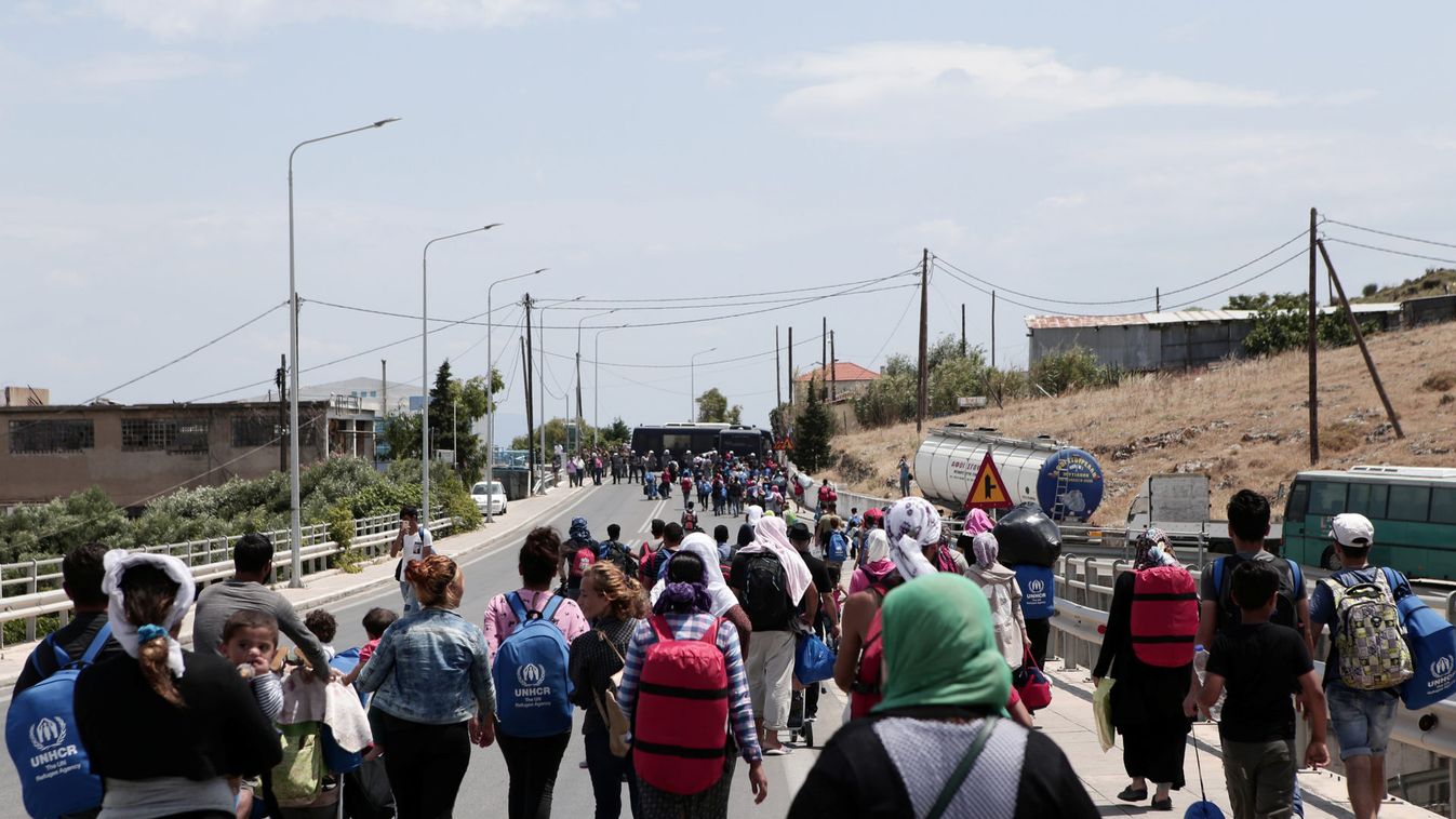 Refugees and migrants from the camp of Moria march towards Mytilene during a protest over the camp's conditions, near the city of Mytilene, on the Greek island of Lesbos