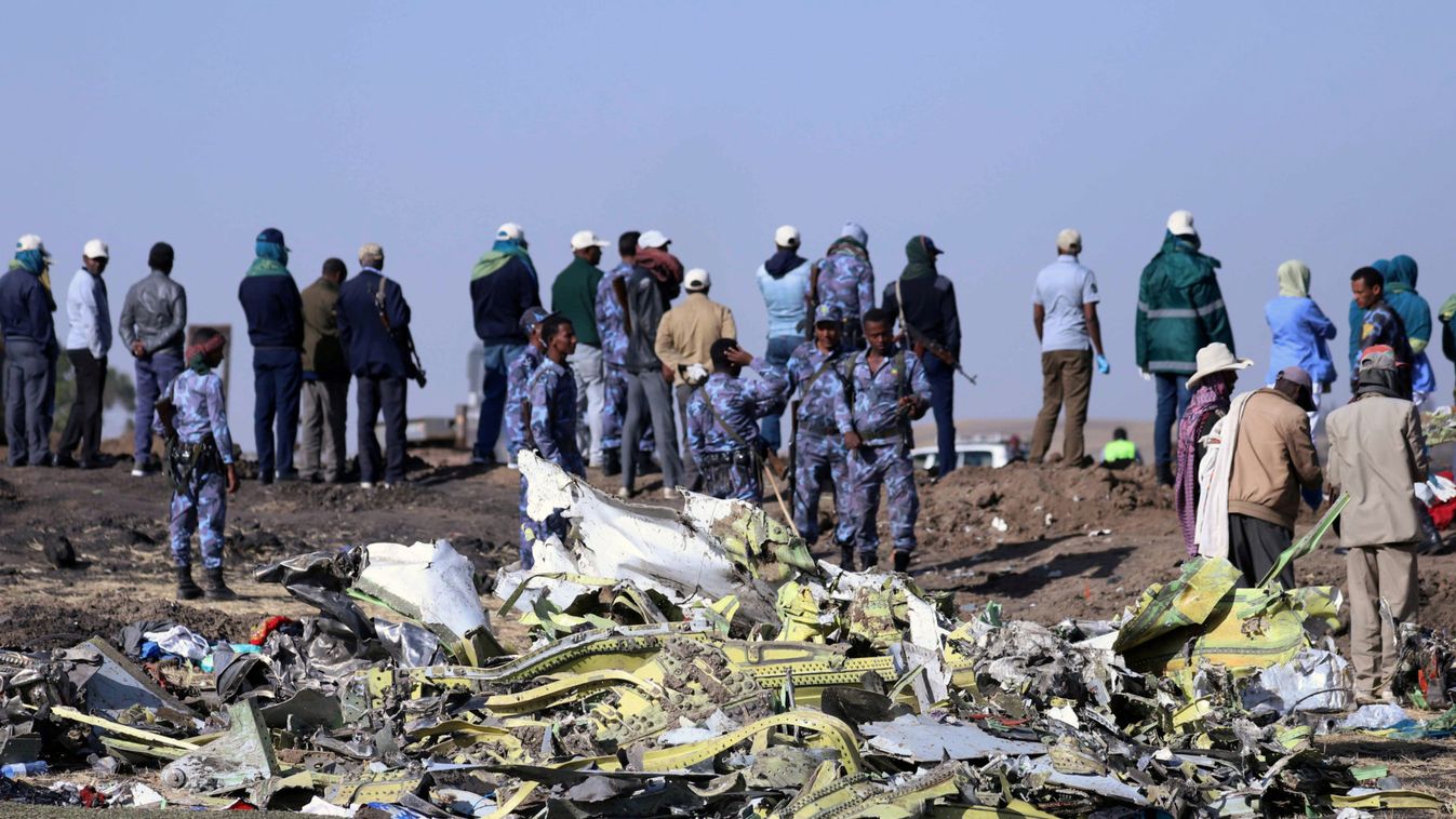 Ethiopian Federal policemen stand at the scene of the Ethiopian Airlines Flight ET 302 plane crash, near the town of Bishoftu