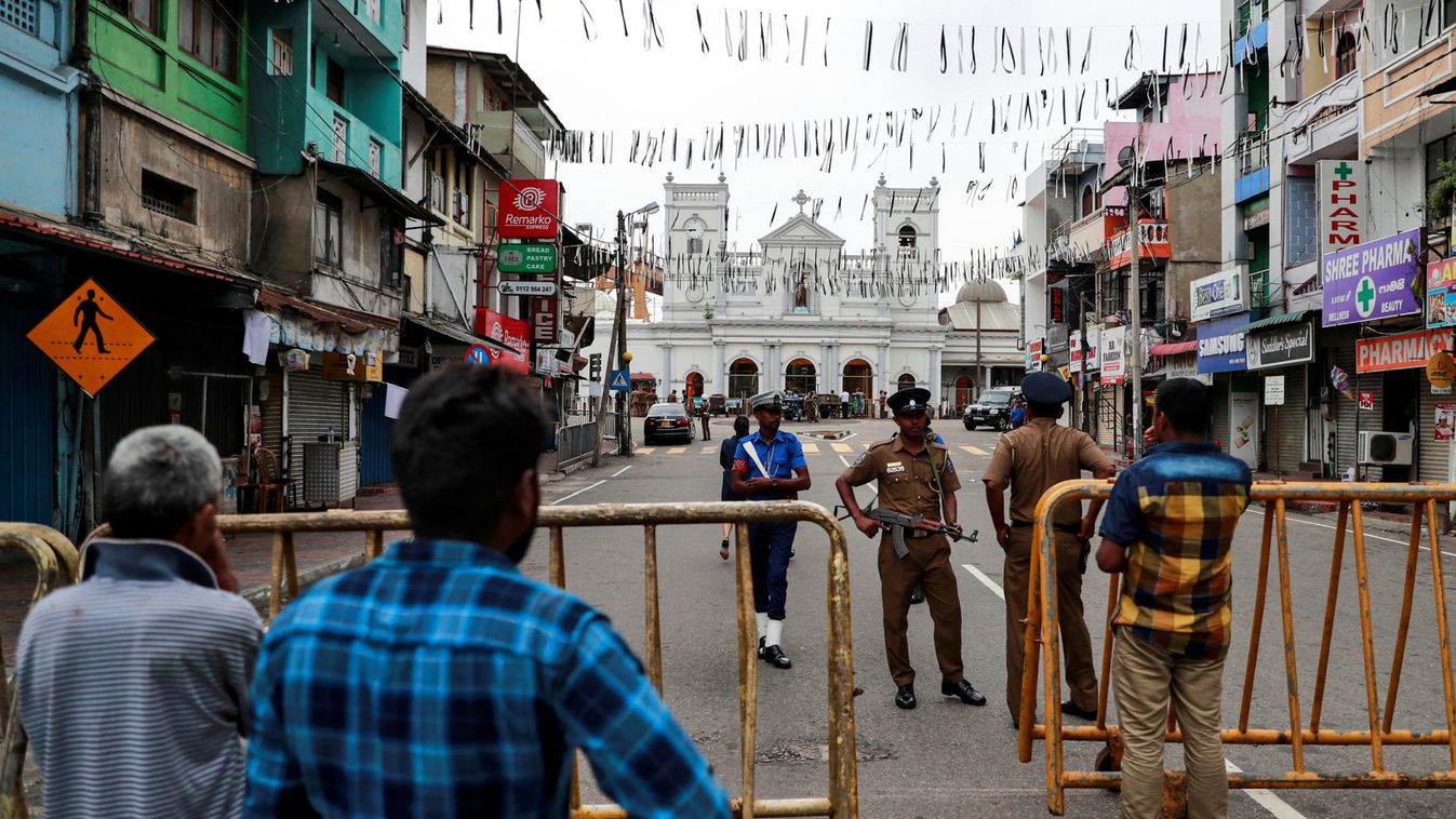 People stand near a security barricade in front of St Anthony's Shrine in Colombo