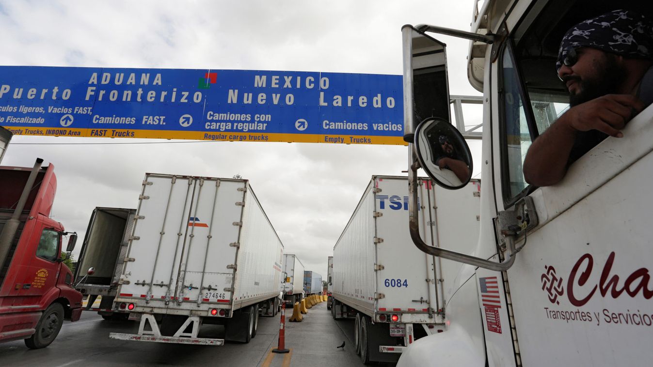 Driver leans out the cabin window while waiting in a queue for border customs control to cross into U.S. at the World Trade Bridge in Nuevo Laredo