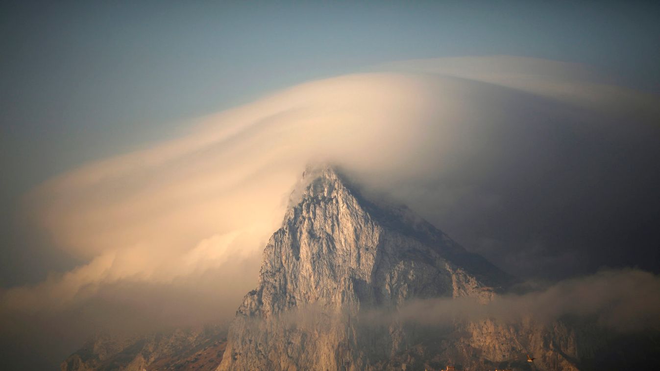 Cloud partially covers Rock of the British territory of Gibraltar at sunrise before Spanish fishermen take part in a protest in Algeciras bay