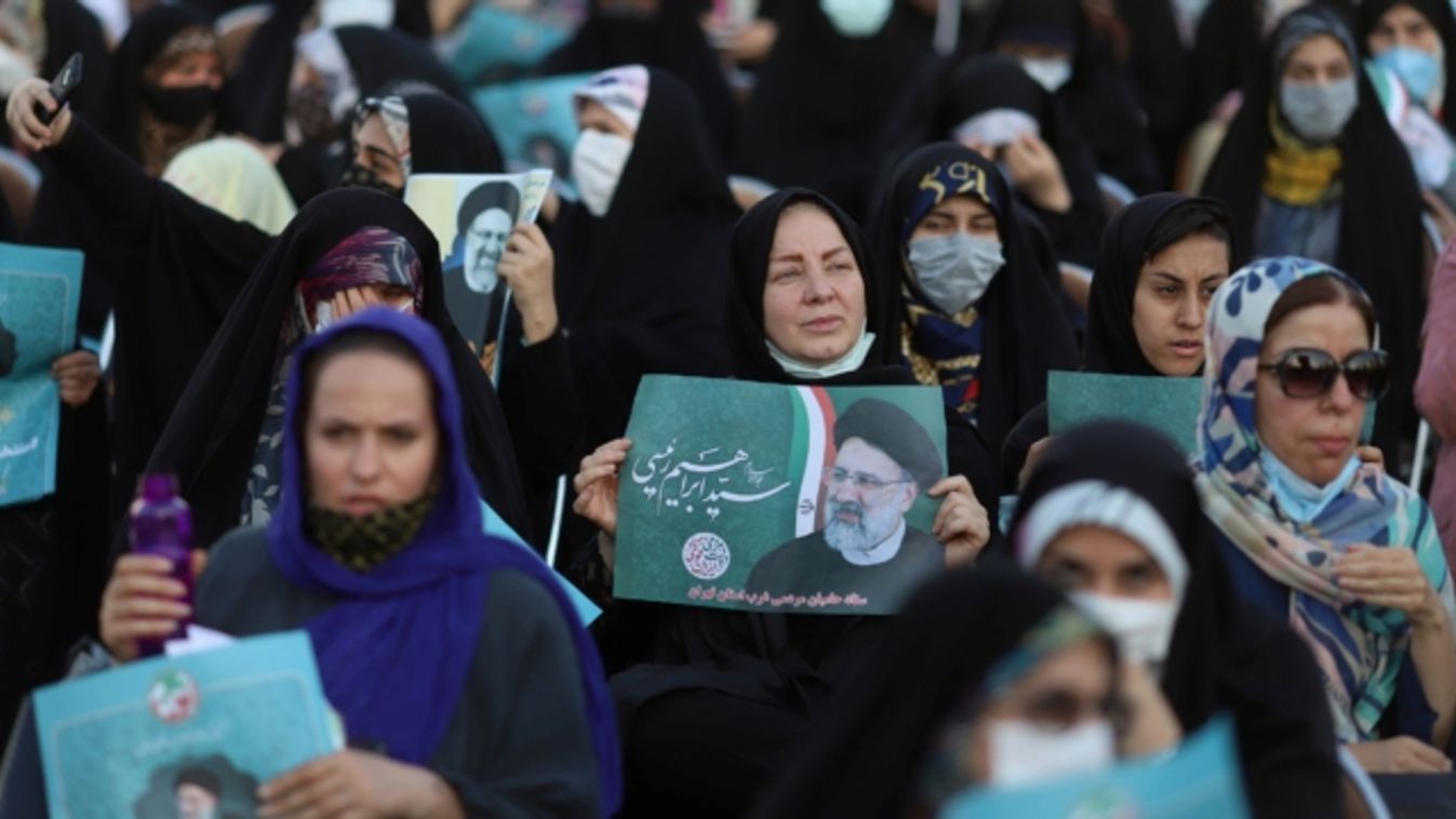 FILE PHOTO: A supporter of presidential candidate Ebrahim Raisi holds a poster of him during an election rally in Tehran, Iran June 14, 2021. Majid Asgaripour/WANA (West Asia News Agency)