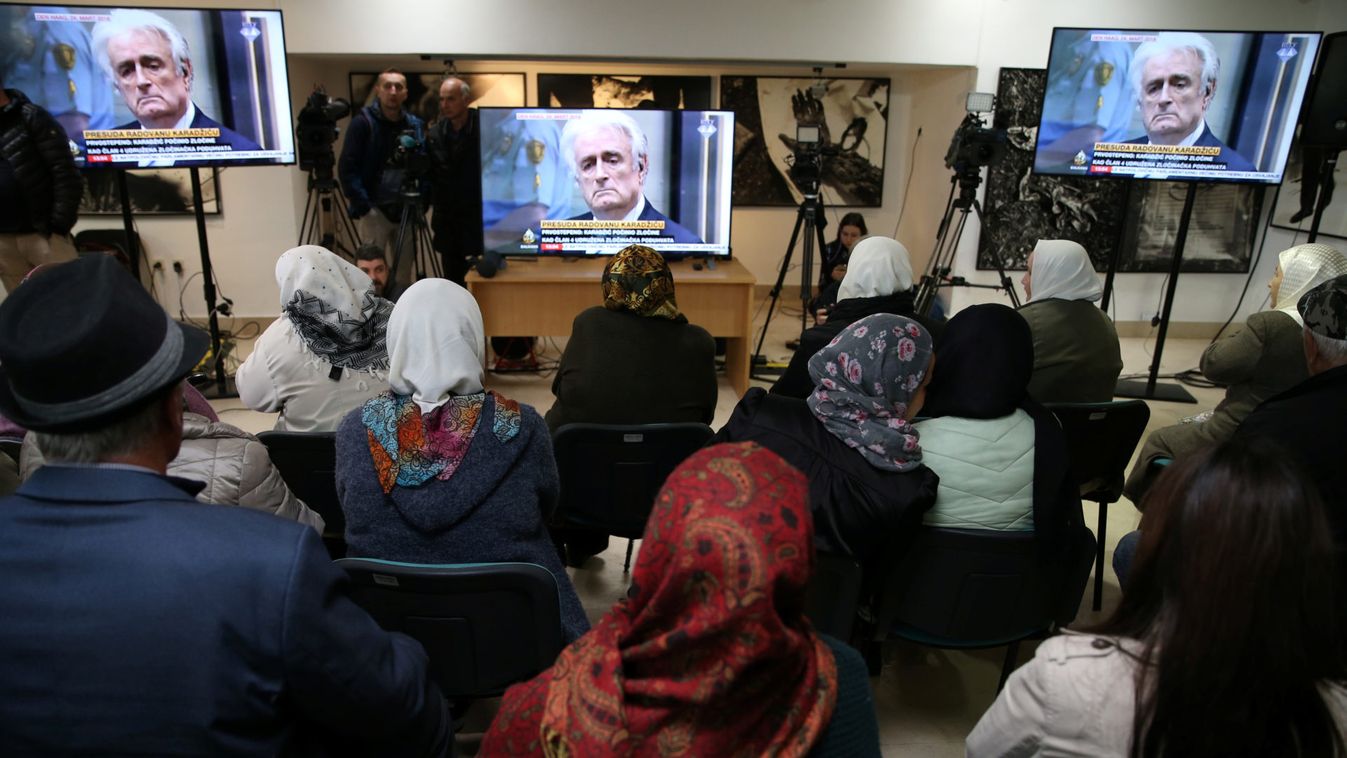 People wait for the judges verdict on former Bosnian Serb political leader Radovan Karadzic's appeal of his 40 year sentence for war crimes, in the Memorial centre Potocari near Srebrenica