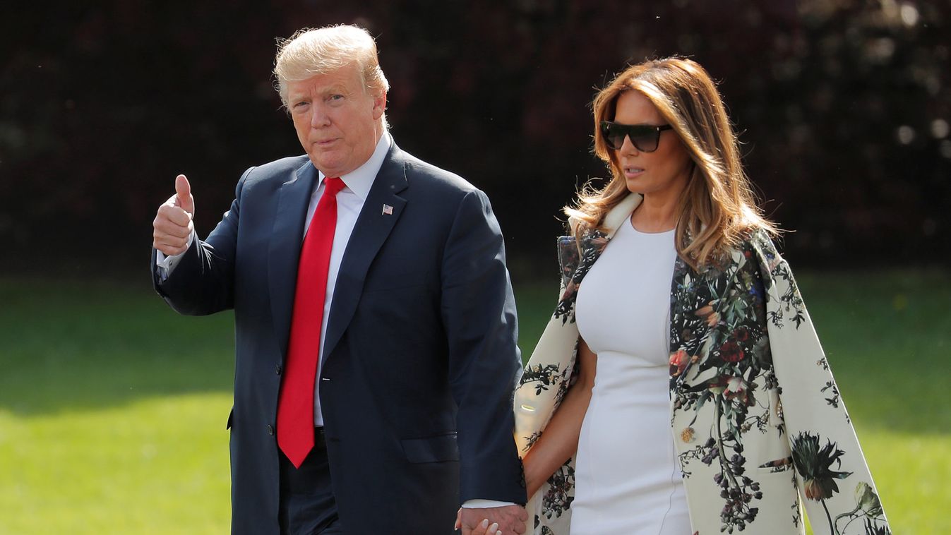 U.S. President Donald Trump gestures alongside First Lady Melania Trump before departing the White House