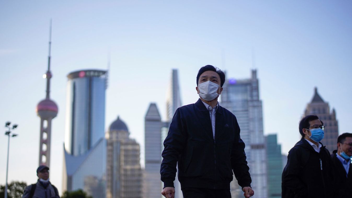 People wear protective face masks, following an outbreak of the novel coronavirus disease (COVID-19), at Lujiazui financial district in Shanghai