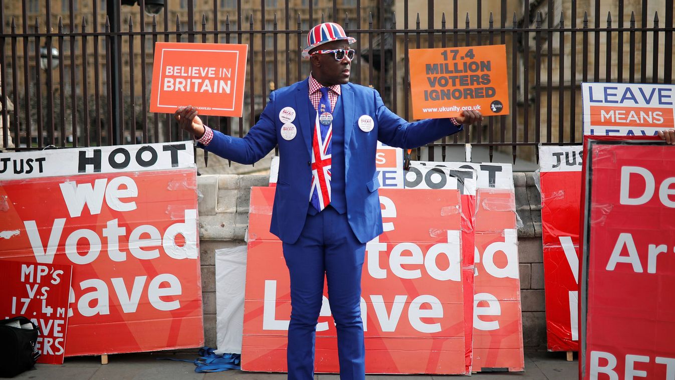 A pro-Brexit supporter walks outside the Houses of Parliament, following the Brexit votes the previous evening, in London