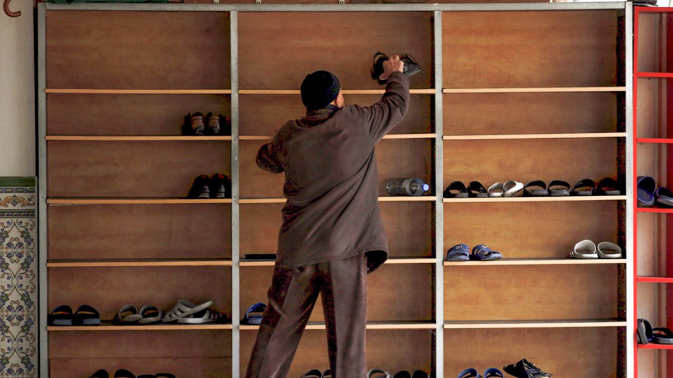 A member of the Muslim community puts away his shoes before the prayers in a mosque in Marseille during an open day weekend for mosques in France