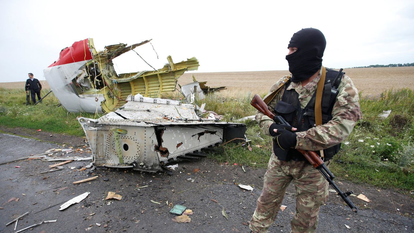 Pro-Russian separatist stands at crash site of Malaysia Airlines flight MH17 near Hrabove