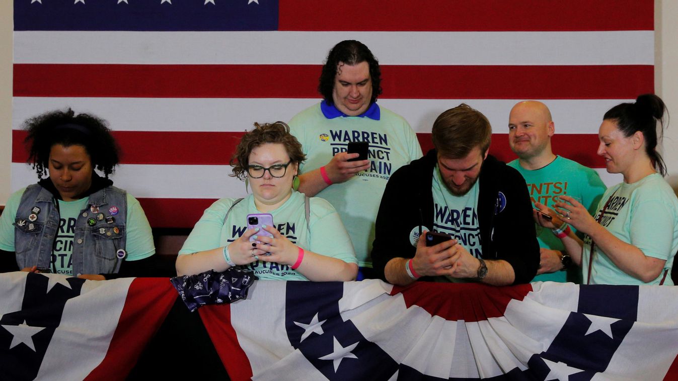 Supporters of Democratic 2020 U.S. presidential candidate Warren look at their mobile phones in Des Moines