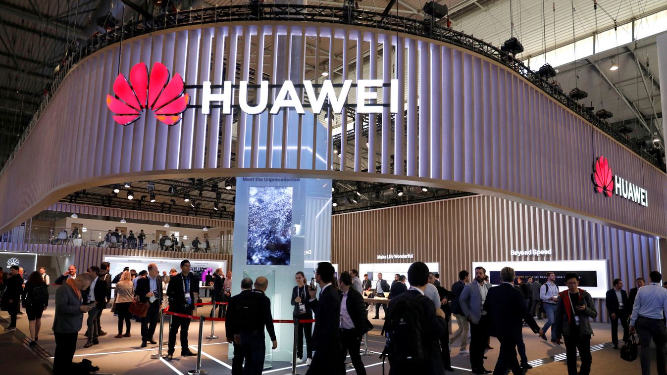 Visitors walk next to Huawei booth at the Mobile World Congress in Barcelona