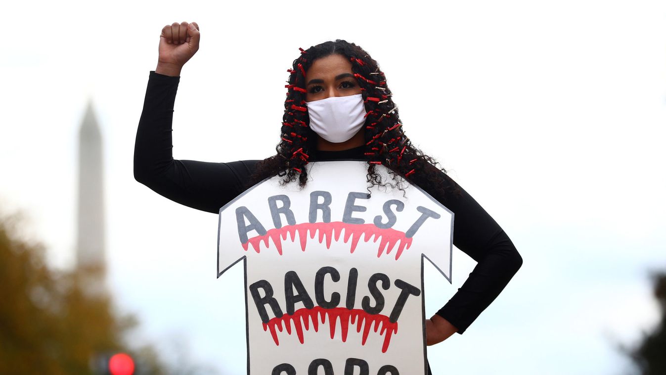 An activist participates in a fashion show to celebrate all black lives on the Black Lives Matter Plaza in Washington