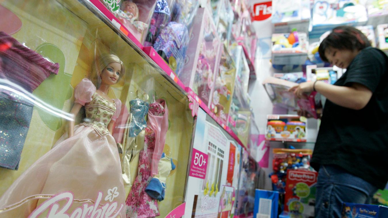 A customer looks at Barbie & Tanner toys at a store in Shanghai