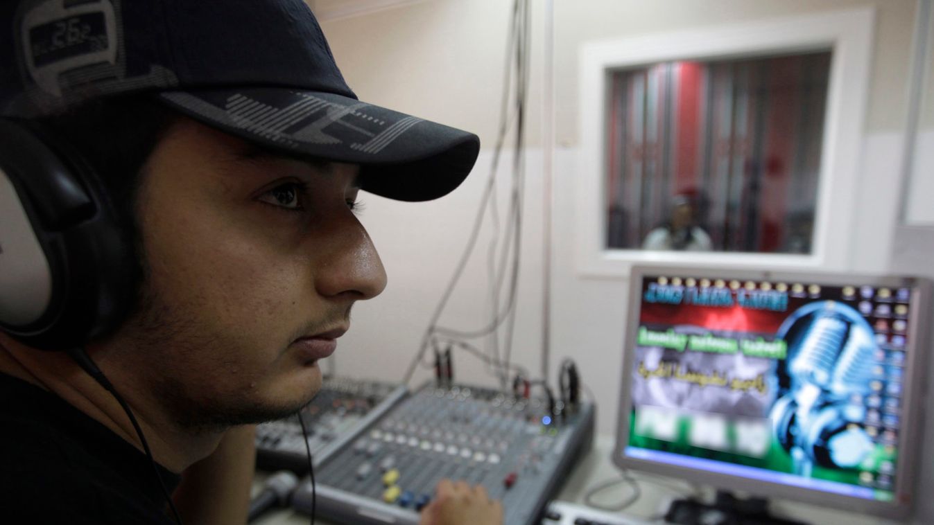 Walid, 27, a radio technician, prepares for a news report at the broadcasting studio of Radio Nafusa al-Hurra in Jado