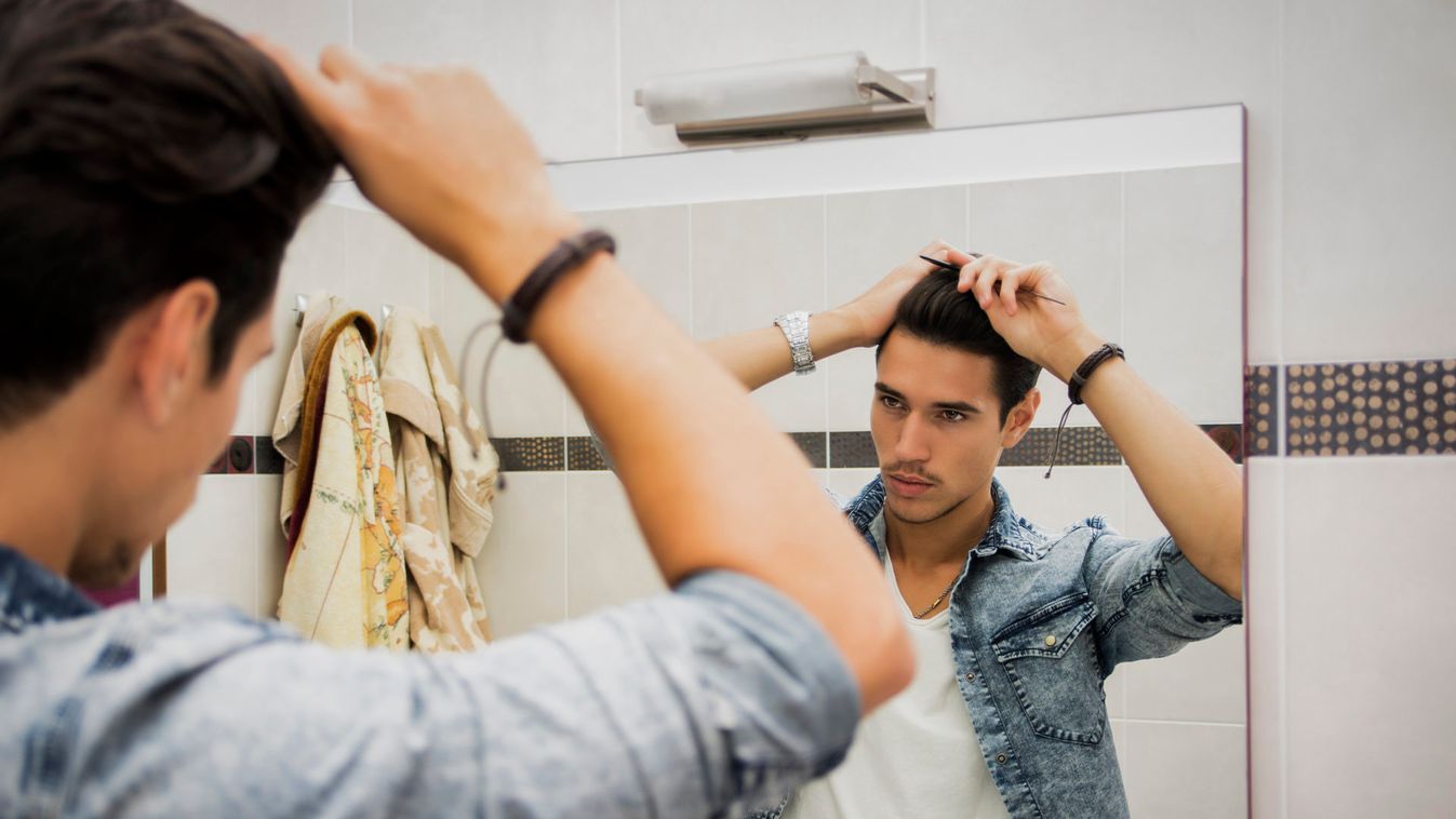 Reflection of Man Bushing Hair in Mirror