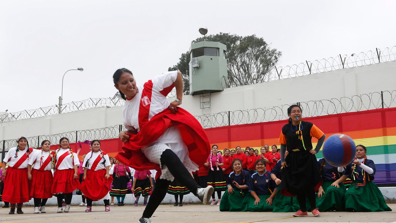 Woman prisoner shoots a penalty during a soccer game before a dance competition inside the Maximum Security prison of Chorrillos in Lima