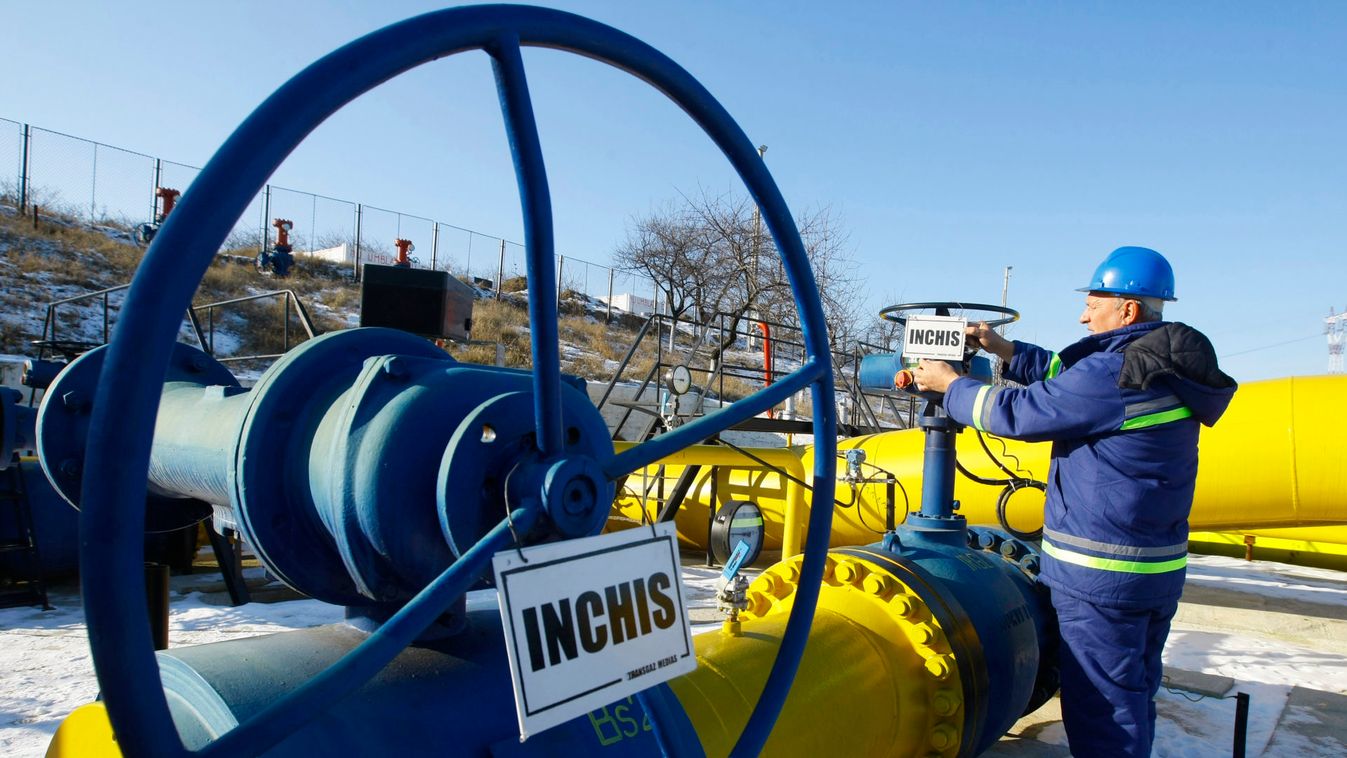 Baciu, a Transgaz operator, arranges a sign reading 'Stop' on a pipeline at the main gas distribution station where pipelines enter Romania from Ukraine in Isaccea