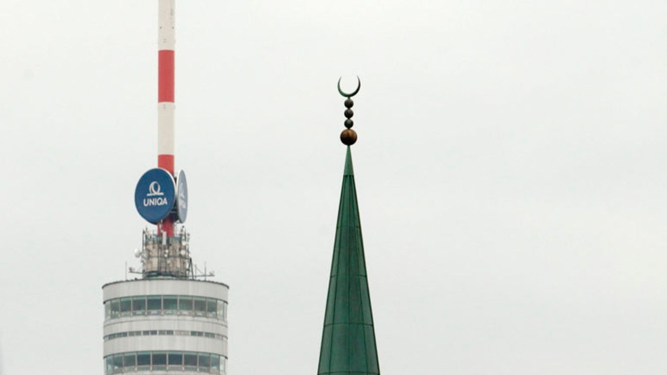 A minaret of the Islamic Centre mosque is pictured next to the Donauturm tower in Vienna