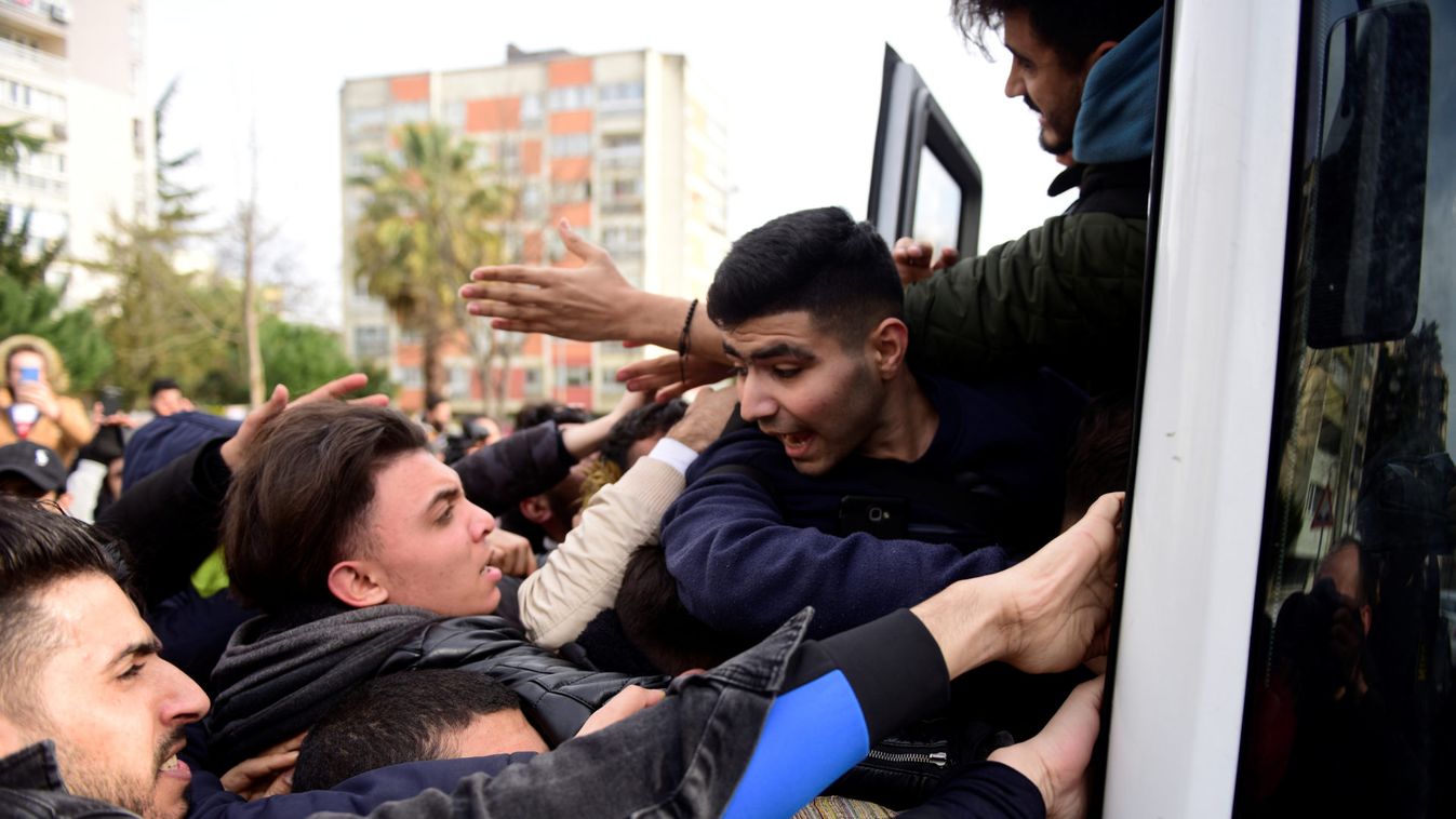 Migrants try to get on a bus which will take them to the Turkish-Greek border, in Istanbul
