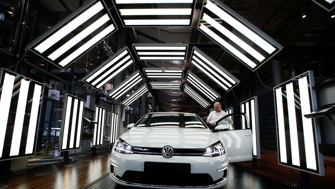 Worker makes final checks on a VW e-Golf electric car in Dresden