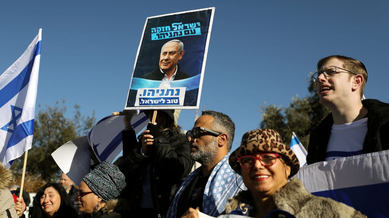 Protesters hold placards as they demonstrate against an Israeli supreme court hearing regarding the legality of Israeli Prime Minister Benjamin Netanyahu forming a new government, in Jerusalem