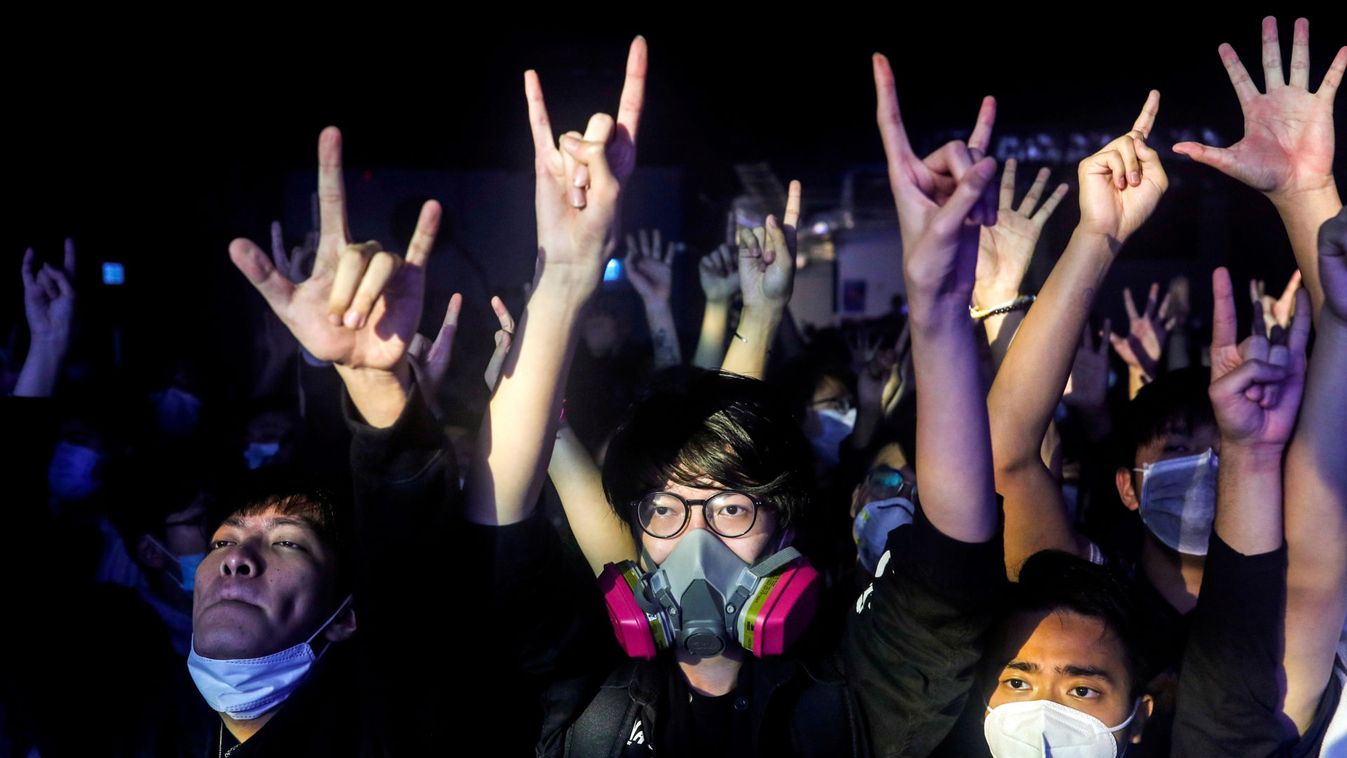 Fans wearing protective masks enjoy a band's performance at Hidden Agenda: This Town Needs (TTN) Live House during the club's last concert as business plummets due to the fear of the coronavirus, in Hong Kong