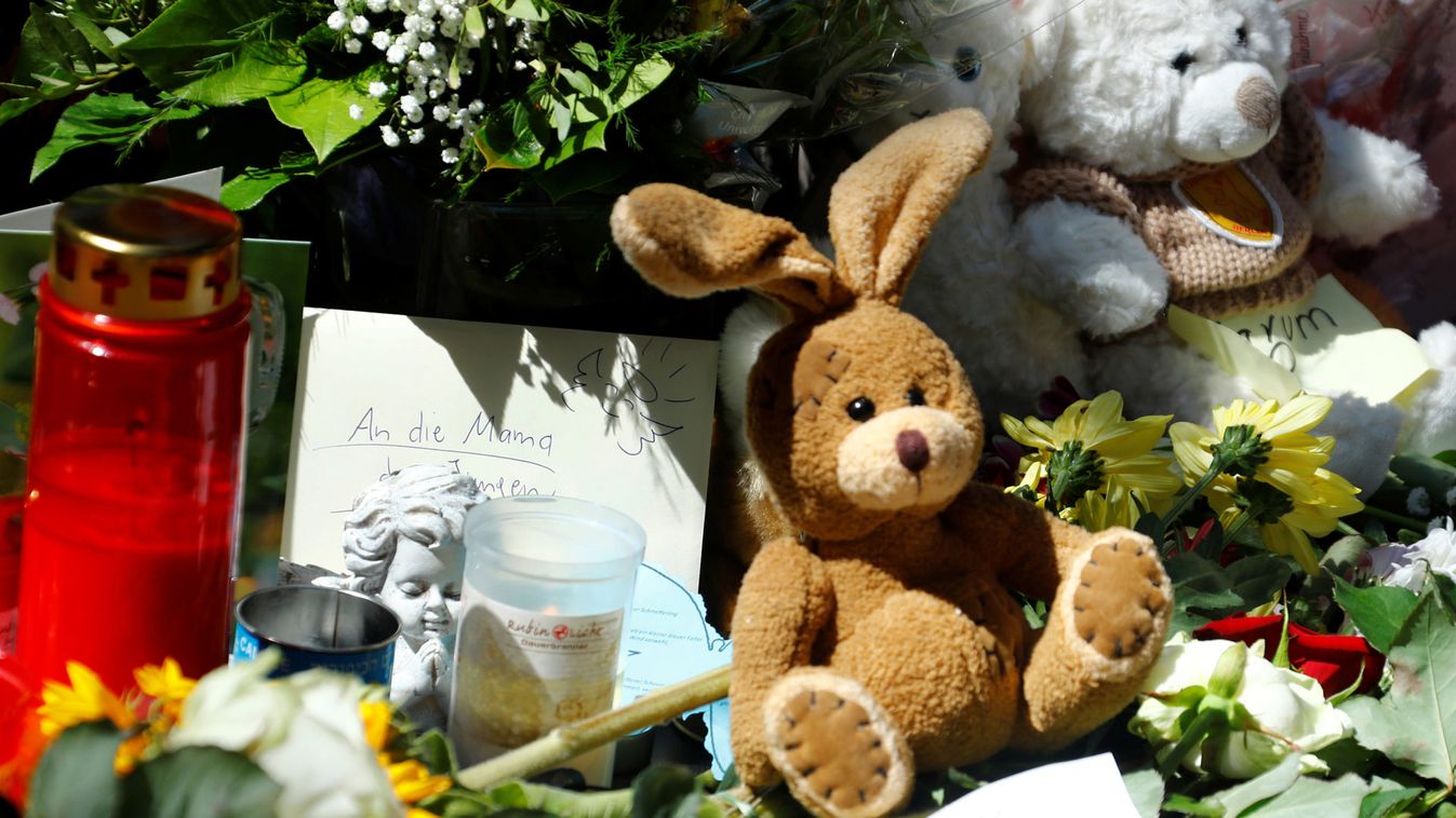 Messages of mourning, candles, flowers and plush toys are placed by people for an eight-year-old boy who was pushed by a man in front of an oncoming train and died at the main train station in Frankfurt