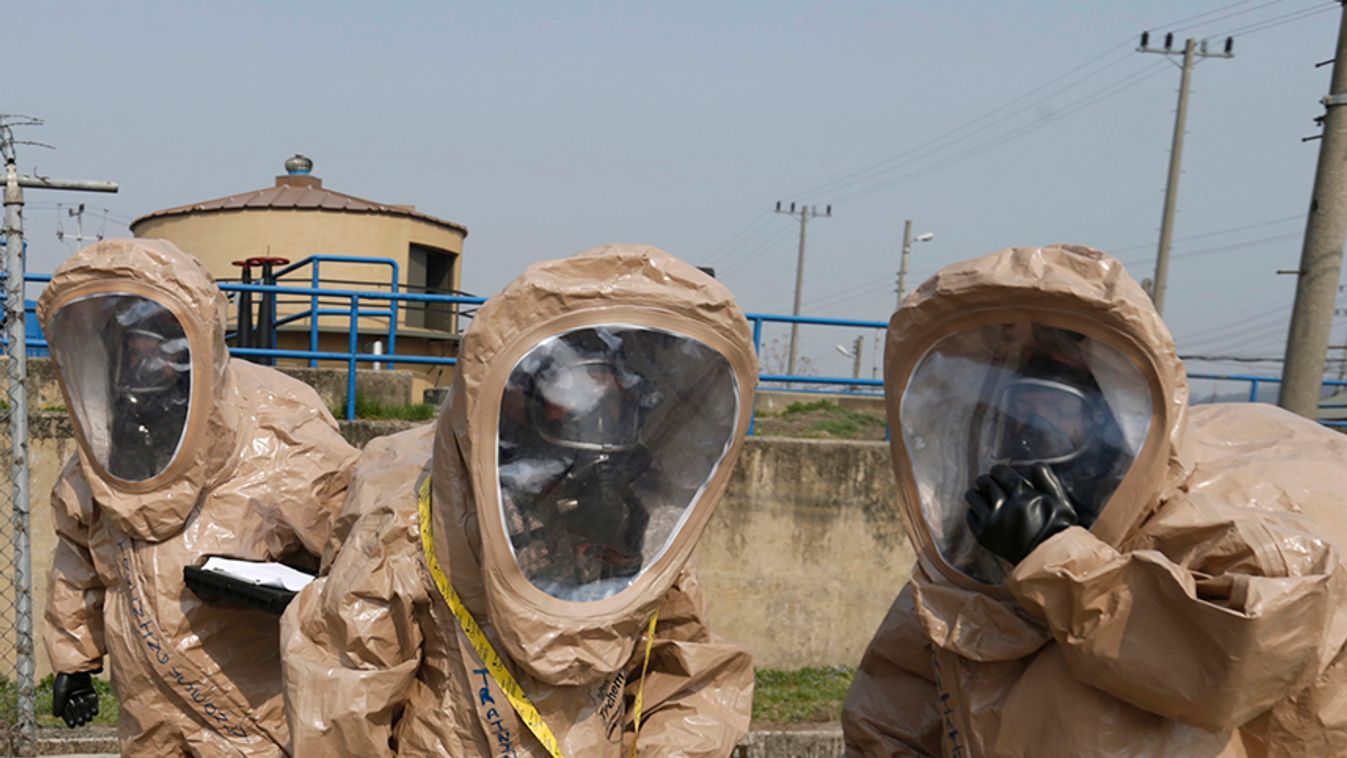 Soldiers of the U.S. Army's 23rd chemical battalion put on their gear during a ceremony in Uijeongbu