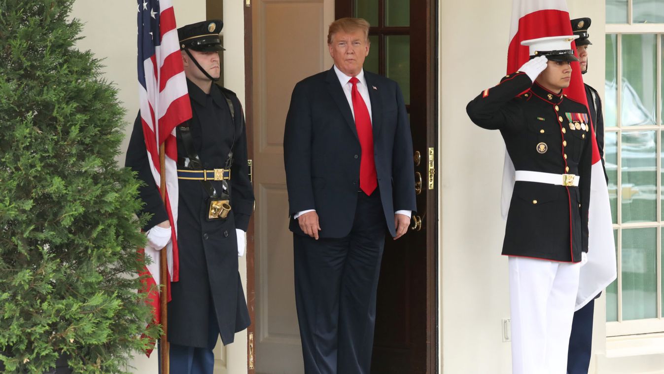 U.S. President Donald Trump waits to welcome Japan's Prime Minister Shinzo Abe at the White House in Washington