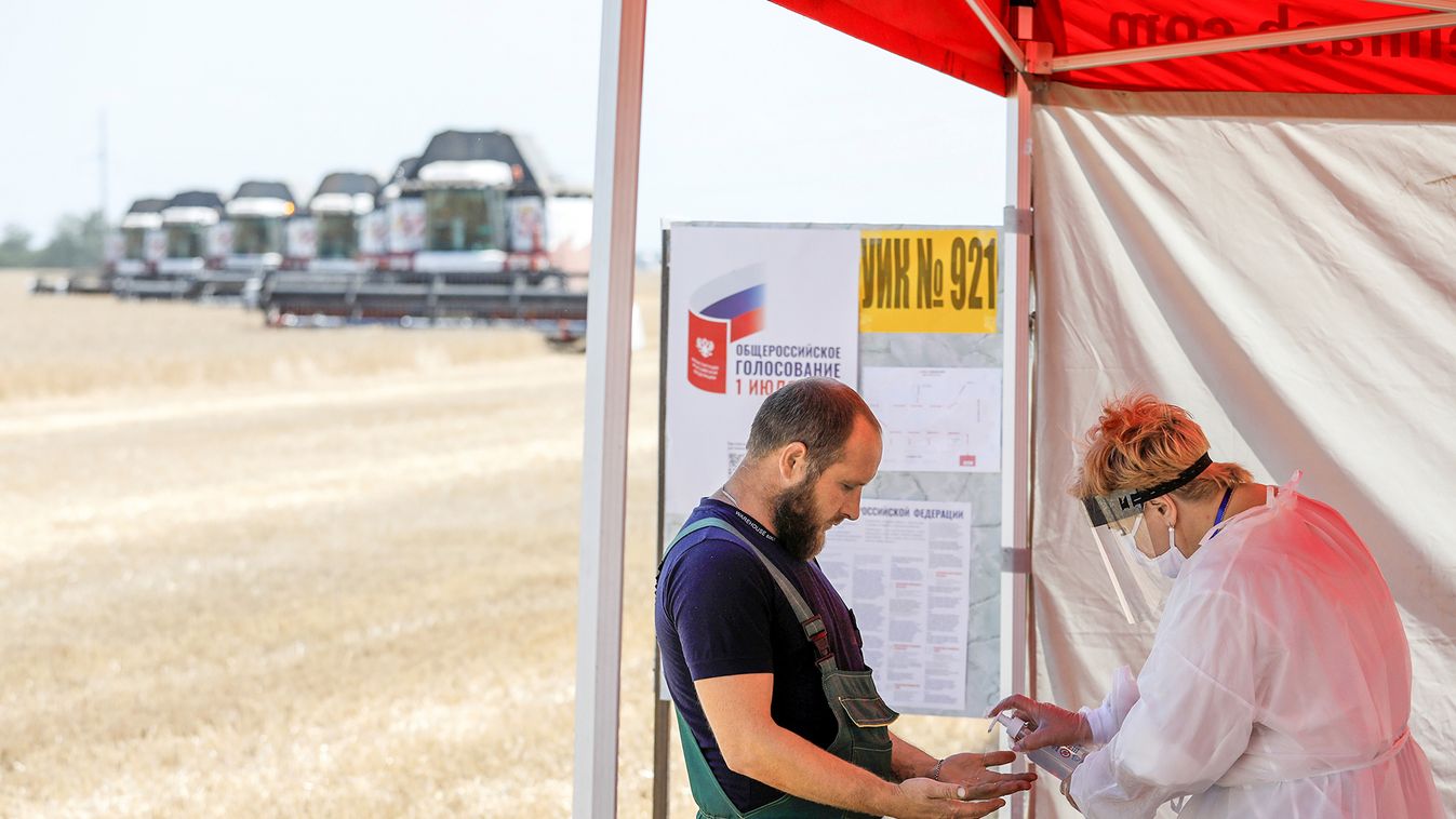 Combine drivers visit a mobile polling station during a nationwide vote on constitutional reforms in Stavropol Region