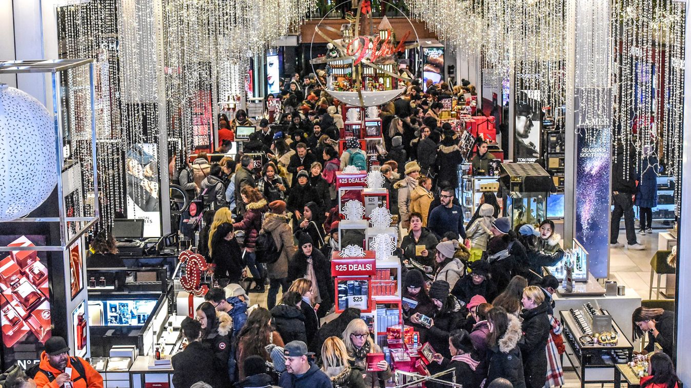 A large crowd of people shop during  a Black Friday sales event at Macy's flagship store in New York City