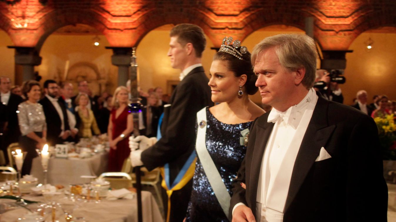 Sweden's Crown Princess Victoria is escorted by Nobel physics Prize winner Schmidt of Australia as they arrive at the Nobel banquet at Stockholm's City Hall