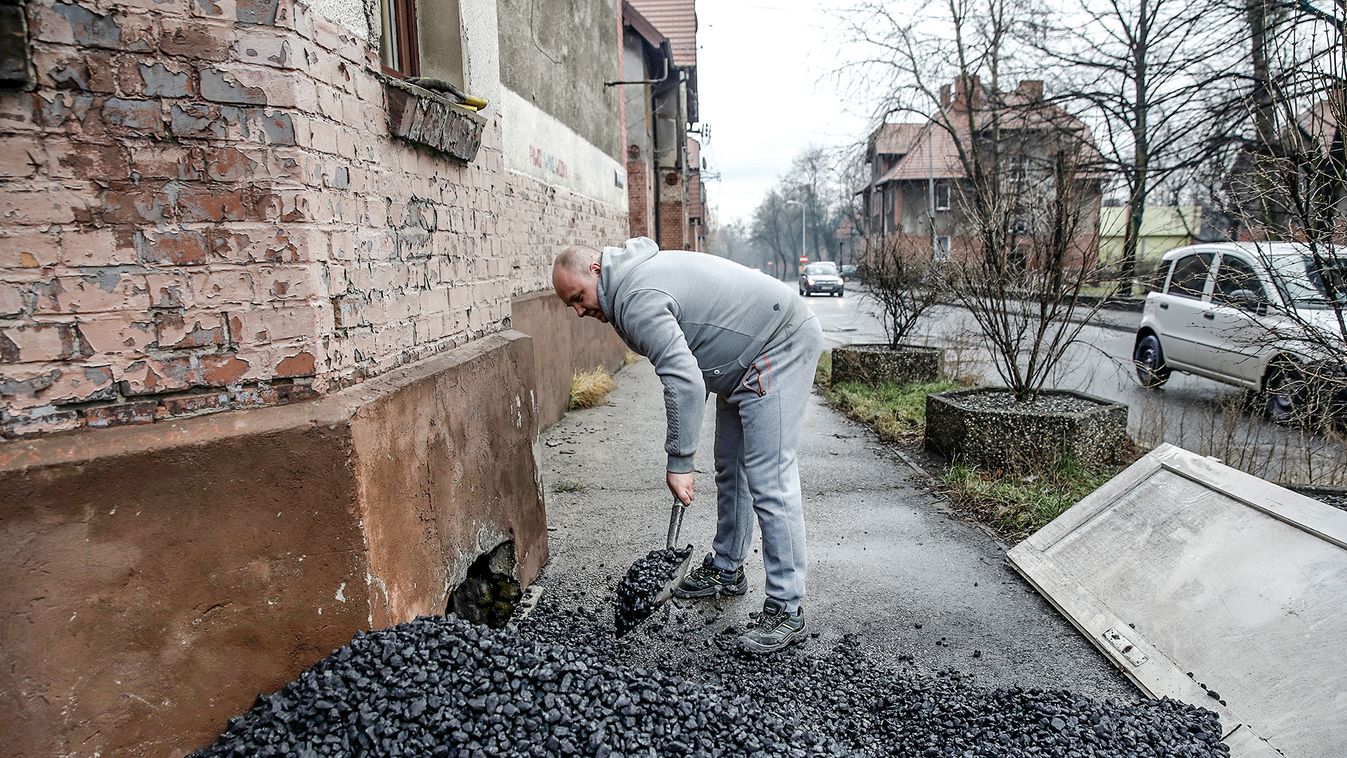 A man loads coal for heating apartment at Bobrek district in Bytom