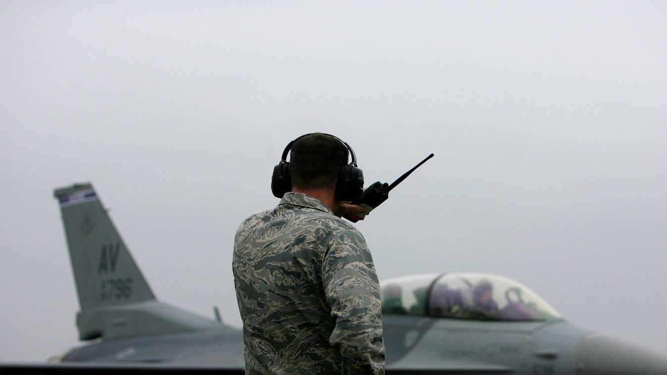 U.S. serviceman watches as F-16 fighter jet prepares to take off at Graf Ignatievo military air base