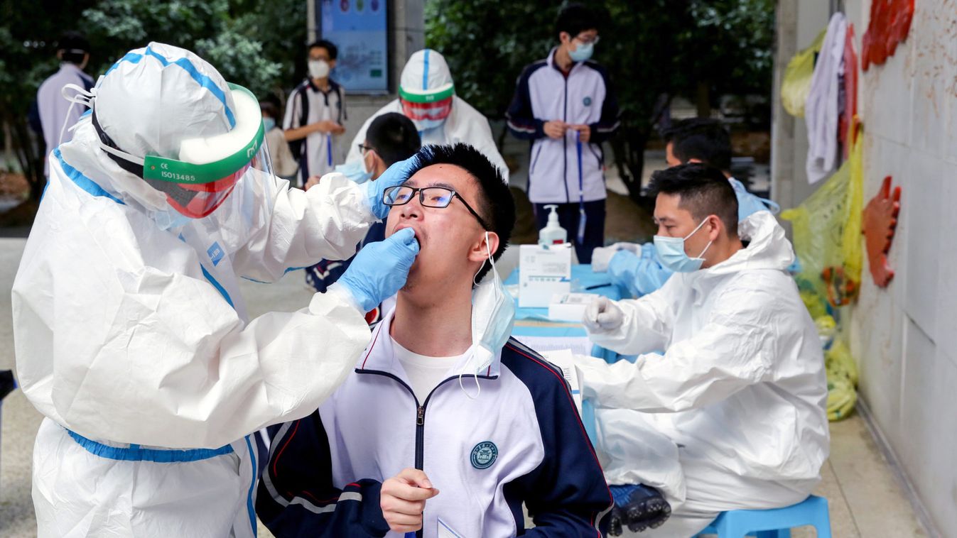 Workers collect swabs from senior high school students for nucleic acid tests in Wuhan