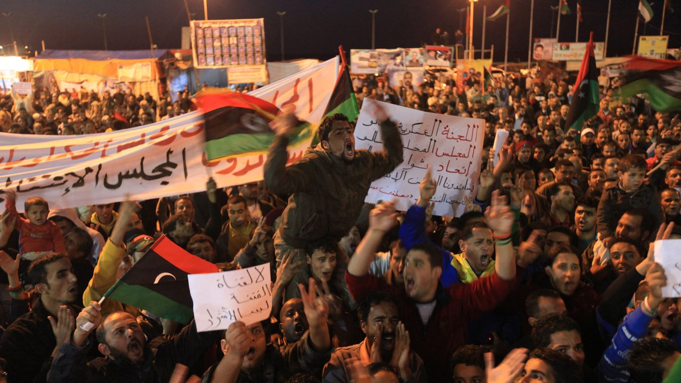 People take part in a rally in support of the National Transitional Council and chairman Mustafa Abdul Jalil near a courthouse in Benghazi