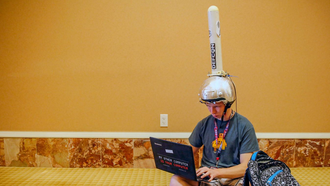 Michael Berna uses a functional antenna attached to his helmet to monitor wi-fi networks during the Def Con hacker convention in Las Vegas