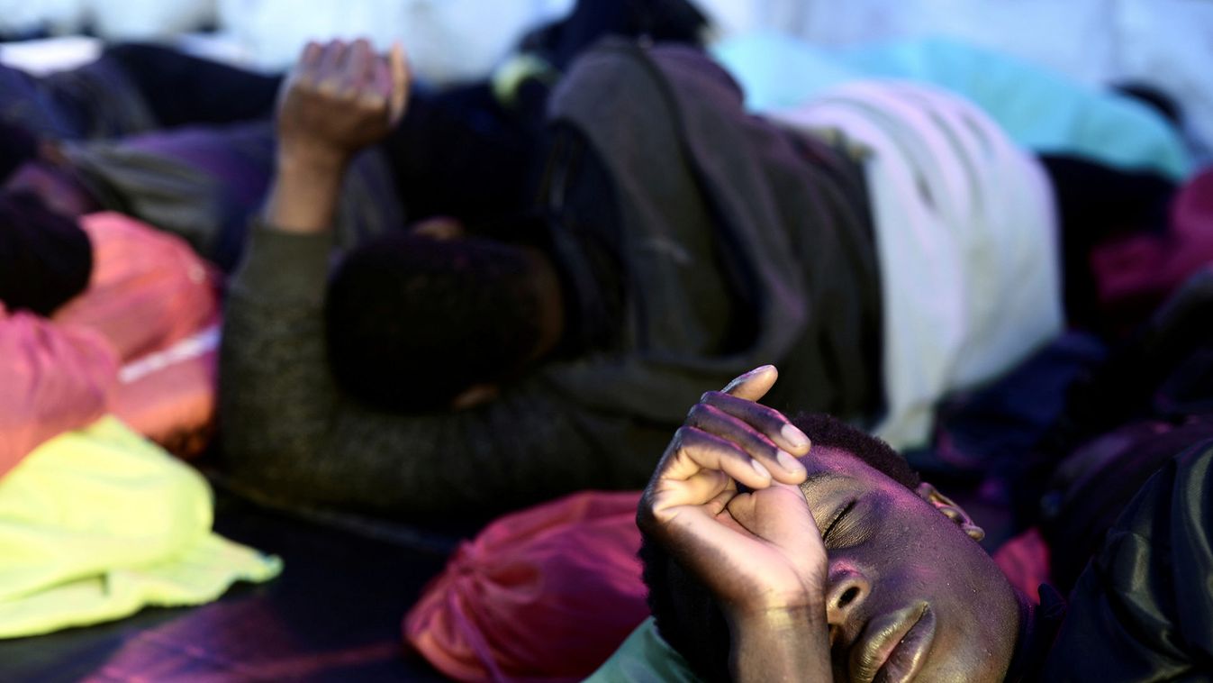 Migrants rest on the deck of  MV Aquarius on their way to Spain
