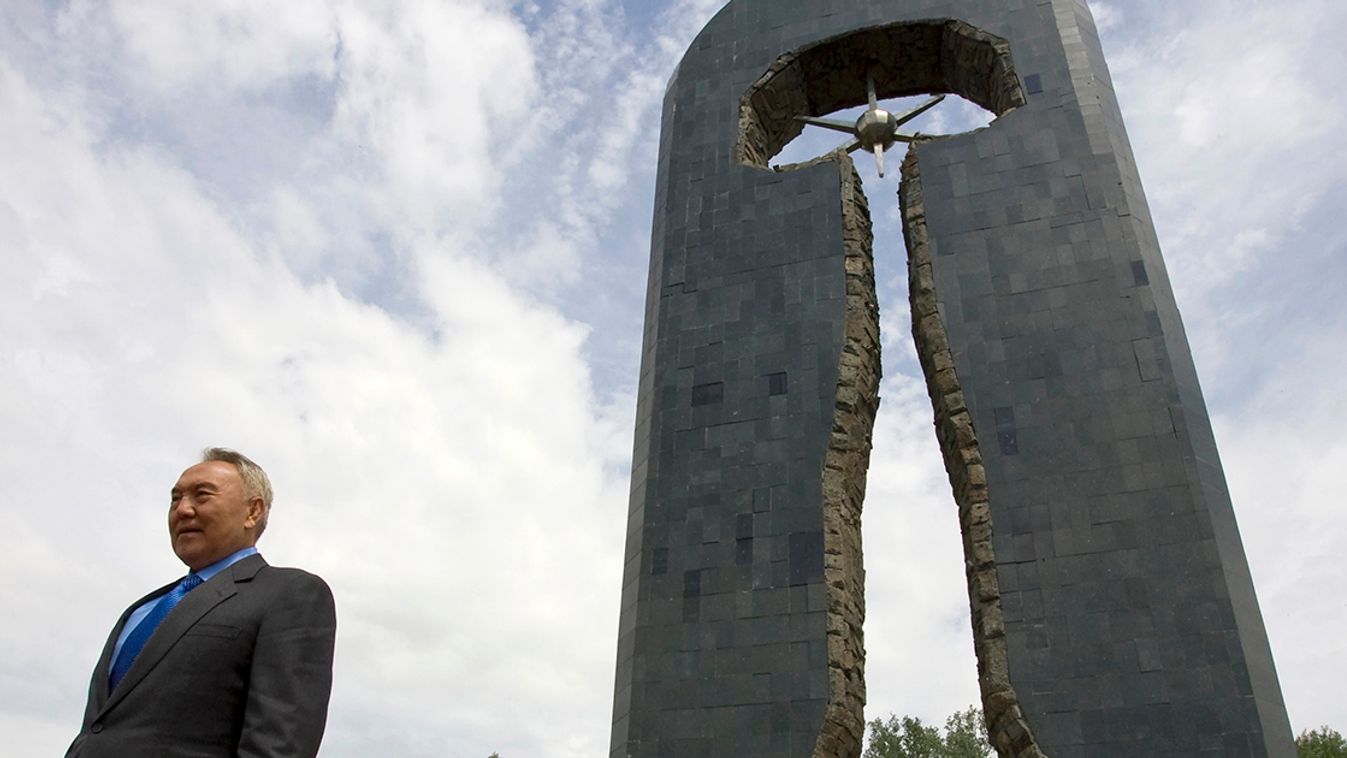 Kazakhstan's President Nursultan Nazarbayev walks in front of the monument "Stronger than Death" in Semei