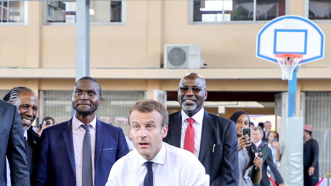 French President Emmanuel Macron to shoot the ball during a meeting with former pro basketball players from NBA Africa and takes part in a practice session with young basketball players in the French Louis Pasteur high school in Lagos