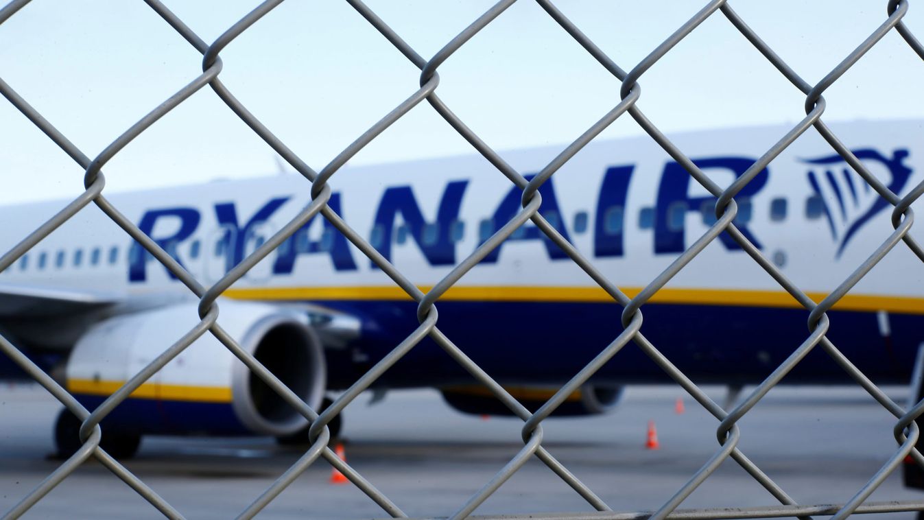 An aircraft of low-cost airliner Ryanair is seen behind a fence while being parked at the tarmac of Weeze airport near the German-Dutch border during a wider European strike of Ryanair airline crews